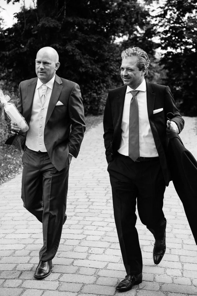 Bräutigam und Trauzeuge auf dem Weg zur Trauung in der Sankt Marien Kirche in Röbel an der Müritz in Mecklenburg Vorpommern beim Hochzeitsfotograf Landhochzeit Hamburg